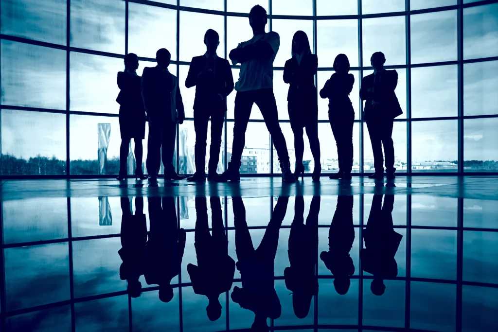 A group of people standing in the shadows, creating a professional and mysterious atmosphere, representing teamwork and expertise in SEO growth.